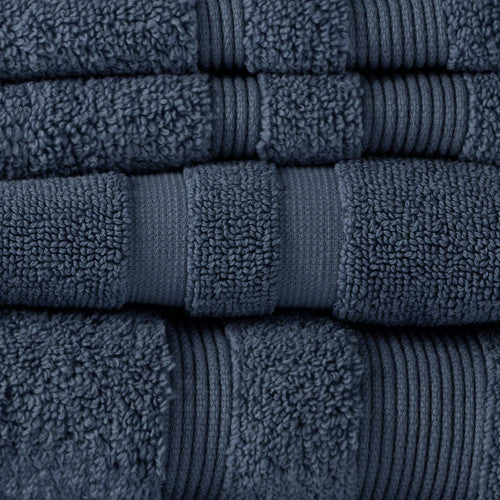 A stack of super-soft Canningvale Amalfitana Bath Towels, in plush navy blue, neatly folded on a white background.