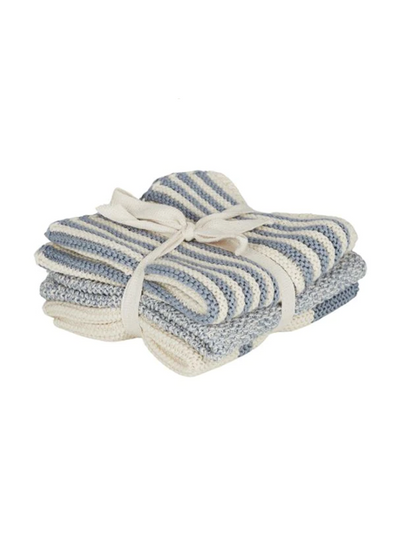 A neatly folded stack of striped towels from the Coast To Coast Amy Cotton Knit Cloth Set - Blue, in shades of blue and white, tied together with a ribbon, against a plain background.