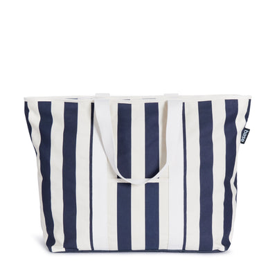 A large striped cotton canvas All Day Base Canvas Bag with navy blue and white vertical stripes, featuring two handles and a label on the side by Base Supply.