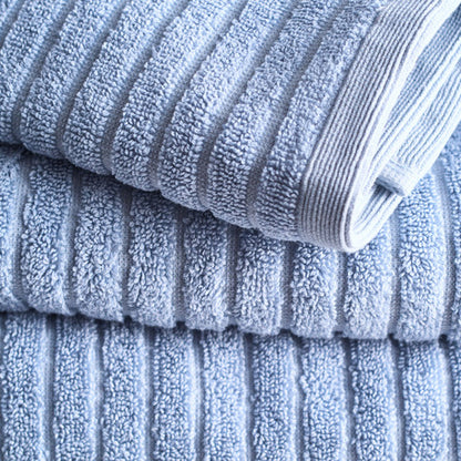 A stack of neatly folded Fresco Blue Alessia Cotton Bamboo Rib Face Towels by Canningvale, with a texture visible on the surface.