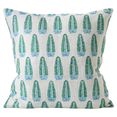 A Walter G Akola Emerald Cushion, with a pattern of stylized blue and green feather or leaf shapes, hand block printed in the style of traditional Indian textiles, arranged in vertical rows on an off-white background.